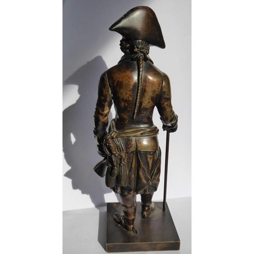 126 - A 19th century patinated bronze of a soldier in bicorn hat; in his left hand he holds a scroll and i... 