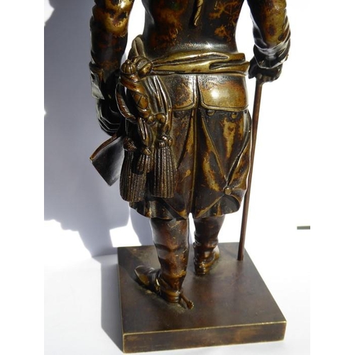 126 - A 19th century patinated bronze of a soldier in bicorn hat; in his left hand he holds a scroll and i... 