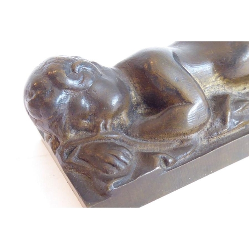 131 - A 19th century continental bronze model of a naked infant asleep upon a robe; good patination and th... 