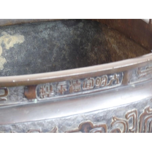 132 - A large mid 19th century patinated Japanese bronze table two-handled temple censer; Xuande mark belo... 