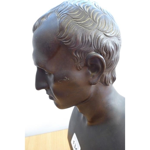 134 - A 19th century patinated bronze bust of Julius Caesar on a variegated rouge marble circular socle ba... 