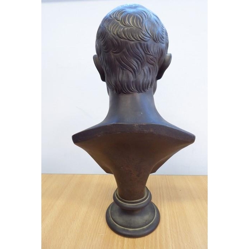 134 - A 19th century patinated bronze bust of Julius Caesar on a variegated rouge marble circular socle ba... 