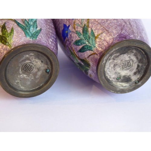 145 - A pair of early 20th century Japanese cloisonné baluster-shaped vases; each decorated with flowers a... 