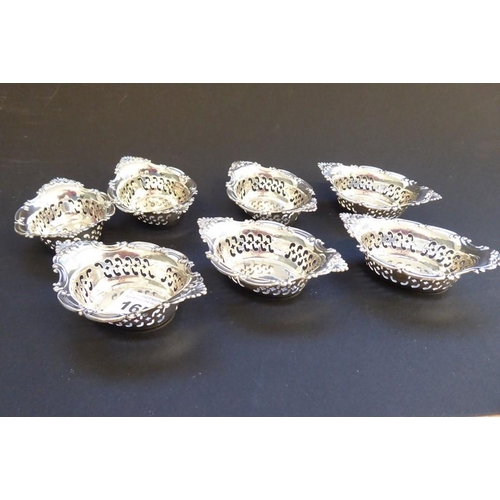 165 - A matched set of seven two-handled boat-shaped silver/sterling silver dishes, each with reticulated ... 