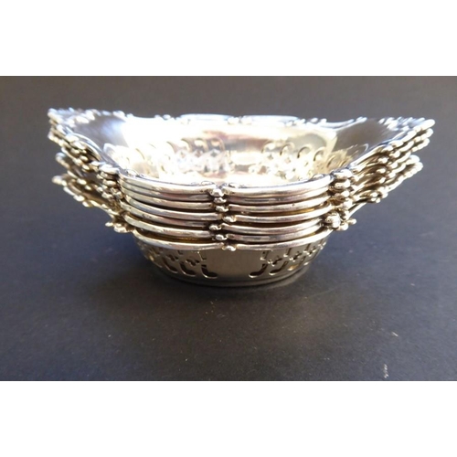 165 - A matched set of seven two-handled boat-shaped silver/sterling silver dishes, each with reticulated ... 