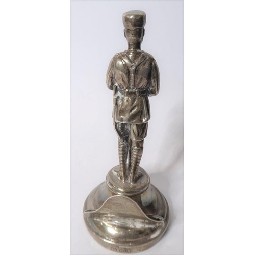 181 - A silver menu holder in the form of an askari of the King’s African Rifles; the Goldsmiths & Silvers... 