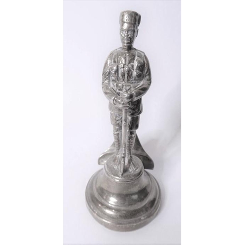 181 - A silver menu holder in the form of an askari of the King’s African Rifles; the Goldsmiths & Silvers... 