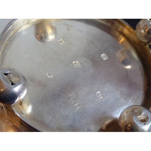 186 - A hallmarked silver teapot; the recessed hinged lid below a gadrooned border and squat spherical bod... 