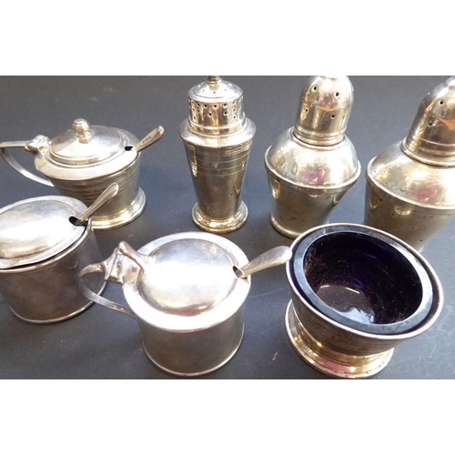 188 - An Art Deco style three-piece hallmarked silver cruet set together with two other slightly larger st... 