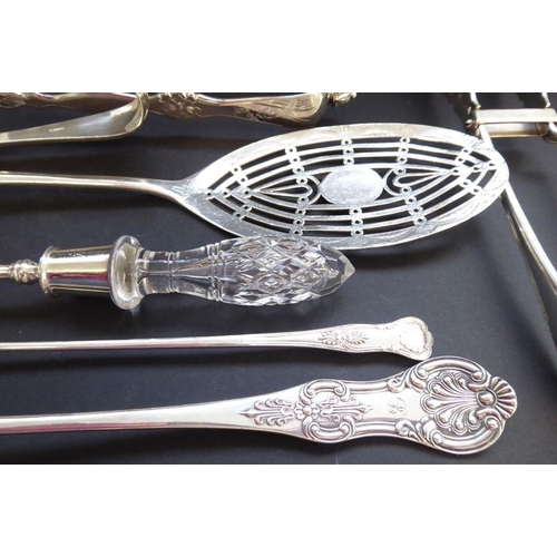 193 - An interesting and ornate selection of late 19th century silver-plated serving tongs, salad servers,... 