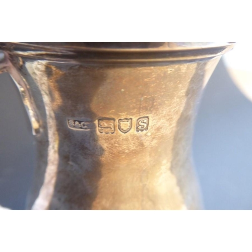 202 - A heavy hallmarked silver baluster-shaped hot-water jug with hinged lid, maker's mark 'S & Co', assa... 