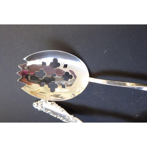 211 - An ornate early 20th century oval serving spoon marked 'sterling' together with one other ladle mark... 