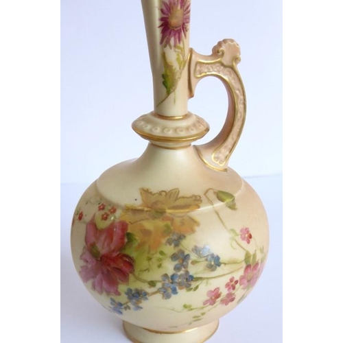 24 - An opposing pair of early 20th century Royal Worcester blush porcelain ewers; each delicately hand d... 