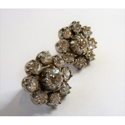 244 - A pair of diamond-set cluster earrings each centrally set with an old brilliant-cut diamond to the s... 