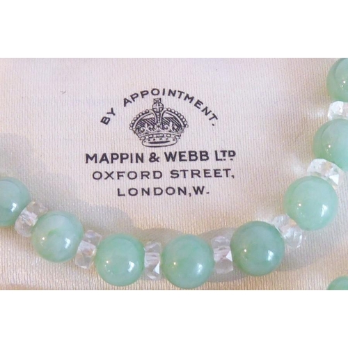 256 - A 1930s Art Deco-period string of graduated green glass jade-coloured beads; the clasp mounted with ... 