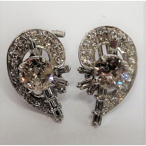 258 - A pair of diamond cluster earrings, the centre stones 1 carat each surrounded by baguette and brilli... 