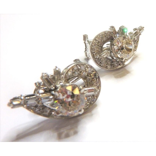 258 - A pair of diamond cluster earrings, the centre stones 1 carat each surrounded by baguette and brilli... 