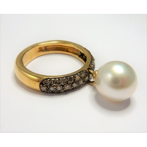 260 - An unusual 18-carat gold diamond and pearl ring; ring size N/O (total weight approx. 7.36g) (The cos... 