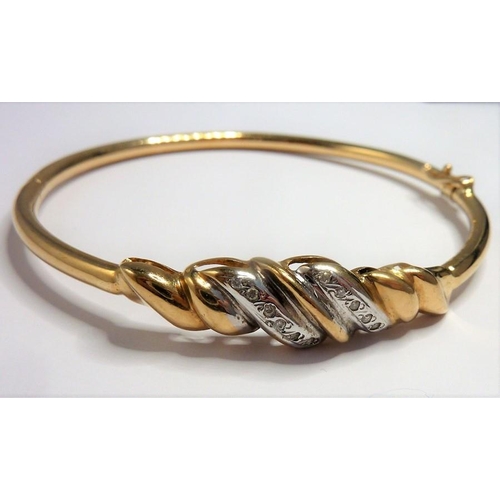 279 - A 9-carat gold and diamond bangle ring size ((total weight approx. 8.58g) (The cost of UK postage vi... 