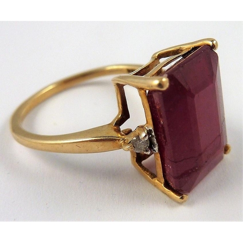 293 - A ladies gold ring set with a large ruby and two small diamonds (The cost of UK postage via Royal Ma... 