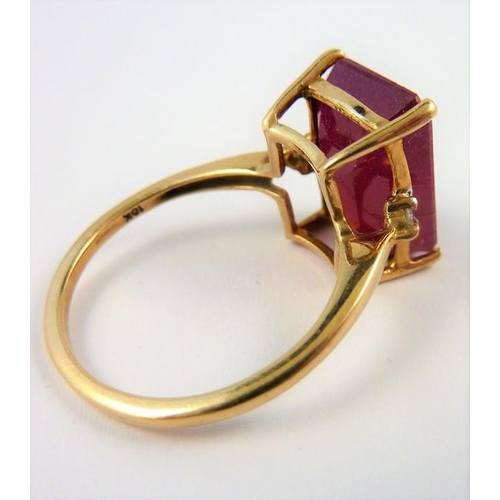 293 - A ladies gold ring set with a large ruby and two small diamonds (The cost of UK postage via Royal Ma... 