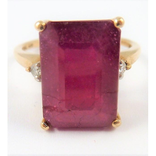 293 - A ladies gold ring set with a large ruby and two small diamonds (The cost of UK postage via Royal Ma... 