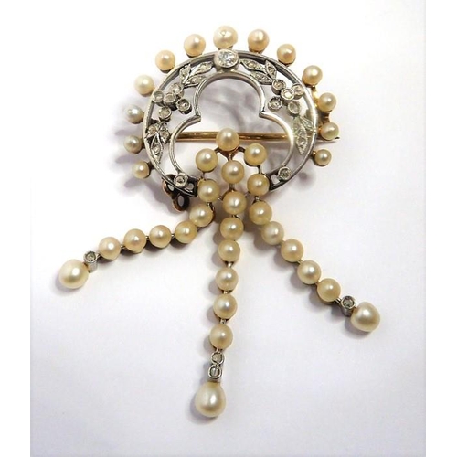 294 - An Edwardian pearl and diamond-set brooch, of openwork design; the floral and foliate diamond-set cr... 