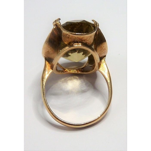 301 - A 9-carat gold ring set with a large citrine; ring size P (total weight approx. 7.4g)  (The cost of ... 