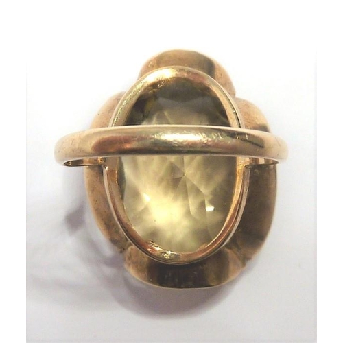 301 - A 9-carat gold ring set with a large citrine; ring size P (total weight approx. 7.4g)  (The cost of ... 