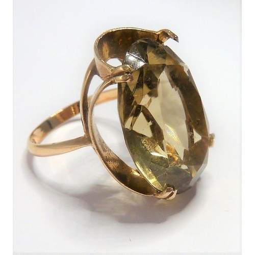 301 - A 9-carat gold ring set with a large citrine; ring size P (total weight approx. 7.4g)  (The cost of ... 