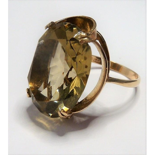 301 - A 9-carat gold ring set with a large citrine; ring size P (total weight approx. 7.4g)  (The cost of ... 