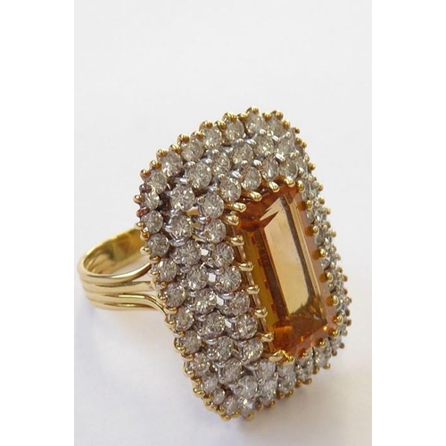 320 - A topaz and diamond-set dress ring, the elongated rectangular-cut cornered topaz set above a three t... 