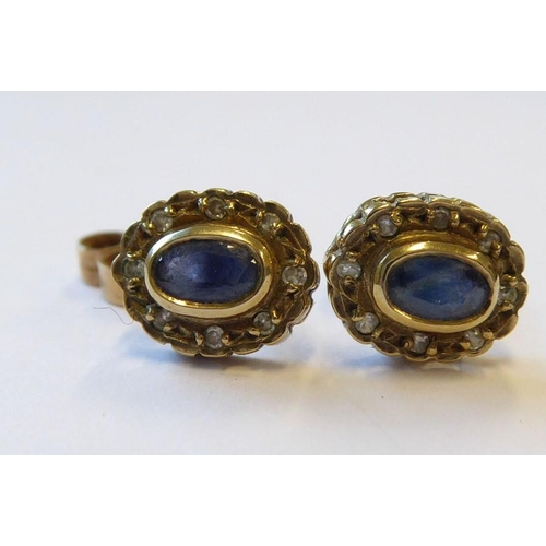 325 - A pair of sapphire and diamond set earrings each with oval-faceted collet-set sapphire within a sing... 