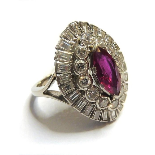 327 - A ruby and diamond-set dress ring; the central navette-shaped ruby claw set above a surround of bril... 