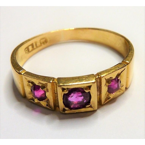 329 - An early 18-carat gold ring set with three rubies; ring size  (The cost of UK postage via Royal Mail... 