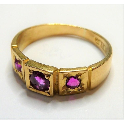 329 - An early 18-carat gold ring set with three rubies; ring size  (The cost of UK postage via Royal Mail... 