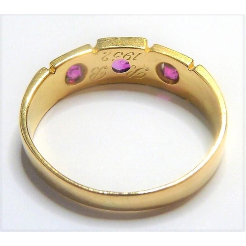 329 - An early 18-carat gold ring set with three rubies; ring size  (The cost of UK postage via Royal Mail... 