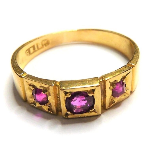 329 - An early 18-carat gold ring set with three rubies; ring size  (The cost of UK postage via Royal Mail... 