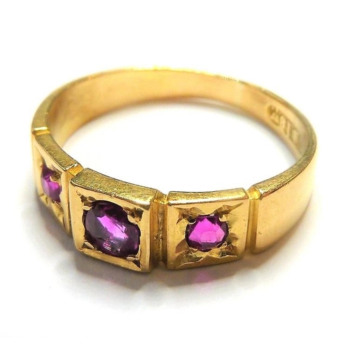 329 - An early 18-carat gold ring set with three rubies; ring size  (The cost of UK postage via Royal Mail... 