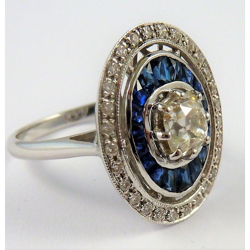 338 - An 18-carat gold sapphire and diamond cluster ring of oval form, the centre diamond 1 carat, ring si... 