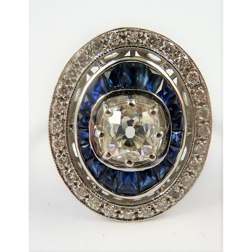 338 - An 18-carat gold sapphire and diamond cluster ring of oval form, the centre diamond 1 carat, ring si... 