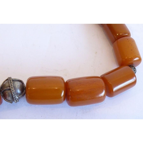 346 - A large 19th century amber necklace set with 18 large barrel-shaped amber beads of burnt-umber colou... 