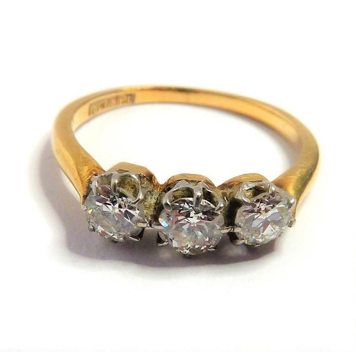 354 - A diamond three-stone ring, the old brilliant-cut diamonds set to the plain 18-carat yellow-gold sha... 