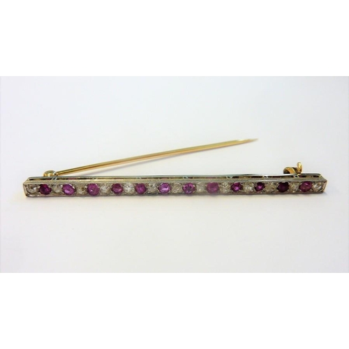 357 - A white and yellow-metal stick pin brooch set with white and pink stones in a horizontal line; the w... 