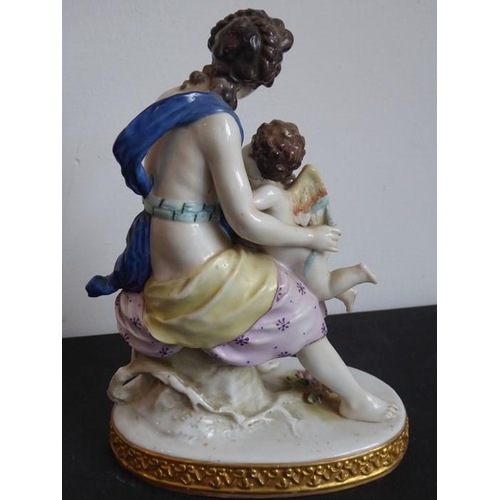 38 - A 19th century hand-decorated Naples porcelain figure model of a scantily clad maiden embracing a wi... 