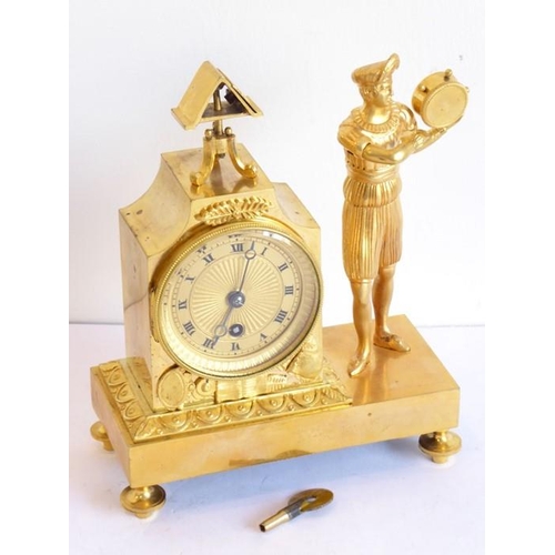 387 - A 19th century French Empire style gilt-metal eight-day figural mantel clock; the textured gold-colo... 