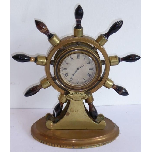 402 - A 19th century novelty brass mantel clock modelled as a ship's wheel with turned varying coloured ag... 