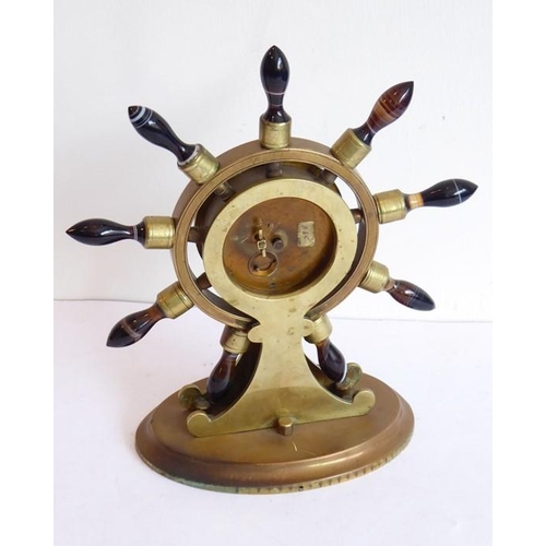 402 - A 19th century novelty brass mantel clock modelled as a ship's wheel with turned varying coloured ag... 