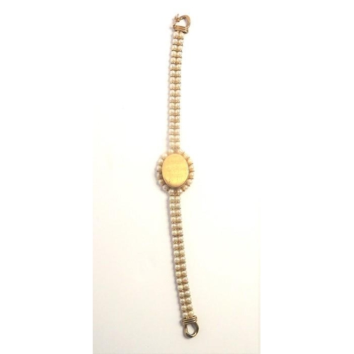 404 - A 9-carat yellow-gold and cultured-pearl wristwatch by Bueche Girod, the plain oval dial signed 'Bue... 