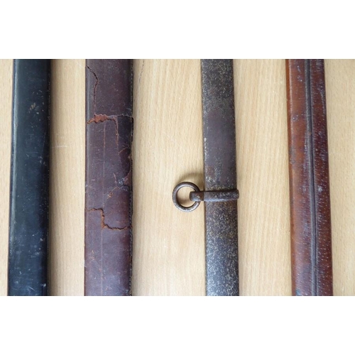 450 - An 1897 Pattern brown-leather sword scabbard together with three other longer antique sword scabbard... 